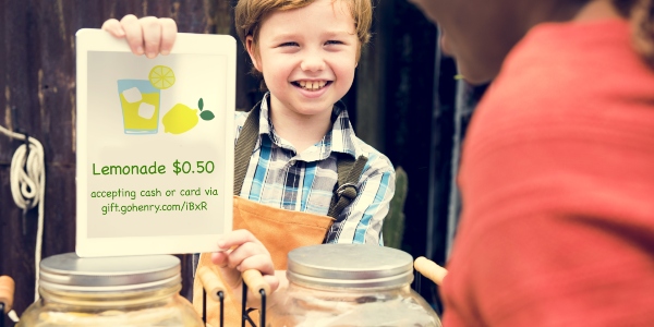 Boy with lemonade stand sign payment option is a Giftlink